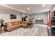 Finished basement with a large comfortable couch and recreational space at 1902 Pioneer Cir, Lafayette, CO 80026