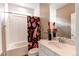 Bathroom with a white vanity, decorative mirror, and a colorful shower curtain at 1902 Pioneer Cir, Lafayette, CO 80026
