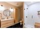 Modern bathroom featuring a walk-in shower, wood cabinet and hexagonal tile flooring at 1902 Pioneer Cir, Lafayette, CO 80026
