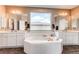 Luxurious bathroom with a soaking tub, dual sinks, and ample cabinet space at 1902 Pioneer Cir, Lafayette, CO 80026