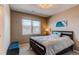 Inviting bedroom featuring a large window, comfortable bed, and stylish decor at 1902 Pioneer Cir, Lafayette, CO 80026