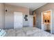 Bedroom with neutral walls, a large bed, and an open doorway to the bathroom at 1902 Pioneer Cir, Lafayette, CO 80026