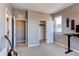 Bedroom with two closets, neutral walls, and a black modern desk in the corner at 1902 Pioneer Cir, Lafayette, CO 80026