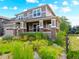 Charming two-story home featuring a welcoming front porch and beautifully landscaped front yard with vibrant flowers at 1902 Pioneer Cir, Lafayette, CO 80026