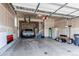 Spacious and well-lit garage with epoxy floor, ample storage space, and room for parking vehicles and other items at 1902 Pioneer Cir, Lafayette, CO 80026