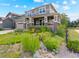 Charming two-story home with a manicured lawn, colorful landscaping, a welcoming front porch, and a two-car garage at 1902 Pioneer Cir, Lafayette, CO 80026