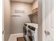 Convenient laundry room with front loading washer and dryer and storage shelf at 1902 Pioneer Cir, Lafayette, CO 80026