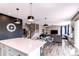 Open living space seamlessly connected to the kitchen with hardwood flooring and modern decor at 1902 Pioneer Cir, Lafayette, CO 80026
