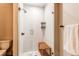 Shower with glass door, white subway tile, and a wooden bench inside at 1902 Pioneer Cir, Lafayette, CO 80026