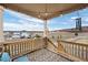 Inviting covered back porch with scenic views, hanging lights, and a comfortable seating area at 2080 Shadow Creek Dr, Castle Rock, CO 80104