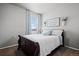 Cozy bedroom with a patterned comforter, accent pillows and bright window at 2080 Shadow Creek Dr, Castle Rock, CO 80104