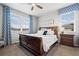 Primary bedroom suite featuring large windows with custom curtains, wood furniture, and plush carpet at 2080 Shadow Creek Dr, Castle Rock, CO 80104