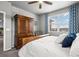 Primary bedroom suite featuring large windows with custom curtains, wood furniture, and plush carpet at 2080 Shadow Creek Dr, Castle Rock, CO 80104