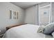 Comfortable bedroom with neutral decor, light blue accents, and bright window at 2080 Shadow Creek Dr, Castle Rock, CO 80104