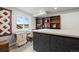 Bright craft room featuring a sewing station, built-in shelving, and natural light from the window at 2080 Shadow Creek Dr, Castle Rock, CO 80104