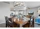 Open concept dining area with modern lighting fixture next to an open kitchen and living area at 2080 Shadow Creek Dr, Castle Rock, CO 80104