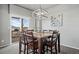 Open dining room featuring a modern chandelier, sliding glass doors to back patio, and decorative wall art at 2080 Shadow Creek Dr, Castle Rock, CO 80104