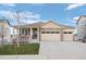 Charming ranch-style home with a covered porch, stone accents, and a three-car attached garage at 2080 Shadow Creek Dr, Castle Rock, CO 80104