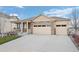 Attractive home with a covered porch, stone details, and a spacious driveway leading to the three-car garage at 2080 Shadow Creek Dr, Castle Rock, CO 80104