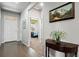 Inviting foyer with a view into a bedroom, showcasing hardwood floors and decorative artwork at 2080 Shadow Creek Dr, Castle Rock, CO 80104