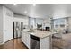 Contemporary kitchen leading into a living area, equipped with stainless appliances and a granite island at 2080 Shadow Creek Dr, Castle Rock, CO 80104