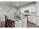 Well-lit kitchen with white cabinets, granite countertops, stainless appliances, and breakfast bar with seating at 2080 Shadow Creek Dr, Castle Rock, CO 80104