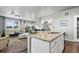 Elegant kitchen with granite counters that seamlessly transitions to a comfy living area and dining space at 2080 Shadow Creek Dr, Castle Rock, CO 80104