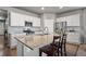 Modern kitchen featuring white cabinets, granite countertops, and stainless steel appliances at 2080 Shadow Creek Dr, Castle Rock, CO 80104