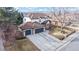 Charming two-story home featuring a three car garage, manicured lawn, and inviting front porch at 11666 W 74Th Way, Arvada, CO 80005