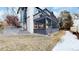 Exterior view of a house with a screened-in porch and a large wooden deck at 11666 W 74Th Way, Arvada, CO 80005