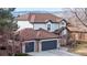 Charming two-story home featuring a three car garage, manicured lawn, and mountain views at 11666 W 74Th Way, Arvada, CO 80005