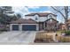 Charming two-story home featuring a three car garage, manicured lawn, and inviting front porch at 11666 W 74Th Way, Arvada, CO 80005