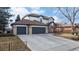 Charming two-story home featuring a three car garage, manicured lawn, and inviting front porch at 11666 W 74Th Way, Arvada, CO 80005