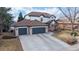 Beautiful home boasting a three-car garage, mature trees, and a well-manicured lawn at 11666 W 74Th Way, Arvada, CO 80005