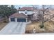 Two-story home with three-car garage, featuring manicured lawn and charming front yard with mature trees at 11666 W 74Th Way, Arvada, CO 80005