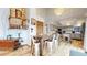 Open-concept dining room leading to a stylish kitchen with custom cabinets and modern appliances at 11666 W 74Th Way, Arvada, CO 80005