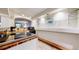 Kitchen area with tile flooring, glass shelves, bar and track lighting at 11666 W 74Th Way, Arvada, CO 80005