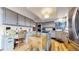 Well-lit kitchen featuring custom cabinets, modern appliances, and an island at 11666 W 74Th Way, Arvada, CO 80005
