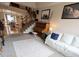 Open-concept living area featuring a piano and seamless access to the dining area at 11666 W 74Th Way, Arvada, CO 80005