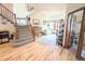 Spacious living room featuring staircase, piano, and access to the adjacent office at 11666 W 74Th Way, Arvada, CO 80005