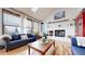 Bright living room boasting large windows, a cozy fireplace, and hardwood floors at 11666 W 74Th Way, Arvada, CO 80005