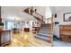 Spacious living room with wood floors, dining area, open staircase and natural light at 11666 W 74Th Way, Arvada, CO 80005
