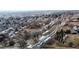 Aerial view of a neighborhood featuring winding streets and a scenic waterway running through the community at 11666 W 74Th Way, Arvada, CO 80005