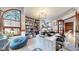 Bright home office with a large window, bookshelf, and modern light fixture at 11666 W 74Th Way, Arvada, CO 80005