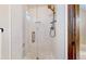 Stylish shower with glass doors, subway tile, and a decorative window at 11666 W 74Th Way, Arvada, CO 80005