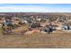 Aerial view showcasing the property's spacious backyard, shed, patio, and mountain views at 5752 Eldorado Cir, Elizabeth, CO 80107