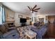 Open living space with a fireplace, ceiling fan, and adjacent dining area, ideal for entertaining at 5752 Eldorado Cir, Elizabeth, CO 80107