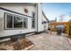 Backyard patio featuring a wooden pergola, stamped concrete, landscaping, and white siding at 9094 W 103Rd Ave, Broomfield, CO 80021