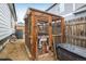 Wooden chicken coop with wire mesh enclosure and warning sign about velociraptor containment at 9094 W 103Rd Ave, Broomfield, CO 80021