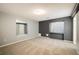 Bedroom with gray accent wall, large mirror, window, neutral carpet, and a light fixture at 9094 W 103Rd Ave, Broomfield, CO 80021